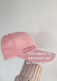 Pale pink cap with rose gold branding